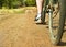 Closeup of bike on dirt track. Focus on foot