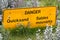 Closeup of a bilingual danger quicksand sign