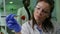 Closeup of biologist woman taking strawberry with tweezers