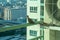 Closeup birds in a nest on the steel cage of air conditioner at the terrace of high condominium with blurred cityscape background