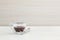 Closeup black coffee in transparent cup of coffee on blurred wooden desk and wall textured background in the meeting room under wi