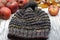 Closeup of Black Grey Handknit Garter Stitch winter hat with apples