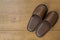 Closeup of Black hotel slippers on wooden ground. Top view.