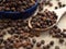 Closeup black pepper sichuan  on spoon and on wood table