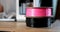 Closeup of black and pink spools of plastic for 3D printer 4k movie slow motion