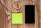 Closeup of black smartphone with headphones and sticky notes on