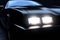 A closeup of a black stock car with silver detailing on the hood and headlights. Speed drive concept. AI generation