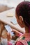 Closeup black teenage girl wearing hearing aids using smartphone in home