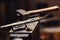 Closeup of a blacksmith anvil with a hammer, tongs, firesteel and flint.