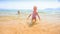 Closeup Blond Little Girl Runs out of Sea to Sand Beach