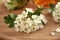 Closeup of blooming hawthorn with a bottle of herbal tincture in the background