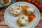 Closeup of blue plate on wood table with homemade minced meat balls gratinated with mozzarella cheese in fresh tomato sauce with