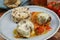 Closeup of blue plate on wood table with homemade minced meat balls gratinated with mozzarella cheese in fresh tomato sauce with