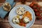 Closeup of blue plate on wood table with homemade minced meat balls gratinated with mozzarella cheese in fresh tomato sauce with