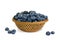 Closeup blueberry in wicker basket and small piles on white background