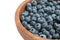 Closeup blueberry in wooden bowl. isolated