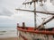 Closeup of boat head of squid fishing boat and light bulb on the beach in the cloudy morning day