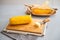 Closeup on boiled corn and butter on cutting board