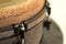 Closeup of a bongo drum under the lights with a blurry background