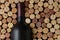 Closeup of a bottle of Cabernet Sauvignon wine surrounded by used corks
