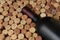 Closeup of a bottle of Cabernet Sauvignon wine surrounded by used corks