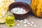 Closeup of a bottle of pumpkin seed essential oil on a napkin with burlap