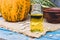 Closeup of a bottle of pumpkin seed essential oil on a napkin with burlap