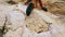 Closeup bottom view female feet in climbing shoes. woman rock climber climbing up the mountain