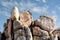 Closeup of a boulder formation in Joshua Tree National Park with blue cloudy sky