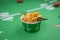 Closeup of bowl of corn chips on football field table runner for