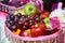 Closeup of bowl of fresh fruits with pink decorations - traditional wedding preparation