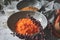 Closeup of a bowl of shredded carrots, cinnamon, and flour, for making carrot cookies