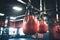 closeup of boxing gloves hanging in a brightly lit gym