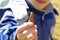 Closeup of boy exploring nature holding small pinecone in his ha