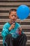 Closeup of boy holding blue balloon, Shanghai, China