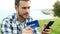 Closeup of a boy paying with credit card and phone