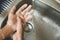 Closeup of a boy scrubbing soapy hand against washbasin