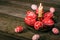 Closeup brass candlestick with Easter red eggs with folk white pattern stand on rustic table and eggs scattered around. Ukrainian