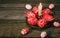 Closeup brass candlestick with Easter red eggs with folk white pattern stand on rustic table. Ukrainian traditional eggs