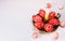 Closeup brass candlestick with Easter red eggs with folk white pattern stand on white background and eggs scattered around. Ukrain