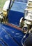 Closeup of a brass lantern and horn on a classic automobile