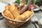 Closeup of bread rolls in basket on table