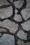 Closeup of brick stone asphalt with black dirt