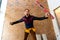 Closeup of bricklayer hands holding hardhat and construction equipment. Handyman with tools belt