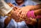 Closeup of Bride, Groom and their parents Joining Hands During an Indian Wedding Ritual