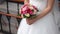 Closeup of bride hands holding beautiful bouquet