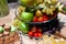 Closeup bright fresh fruits: apples, strawberry, pear, grape, honeycombs cubes in glass bowl, flowers irises, macaroons, truffles