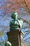 Closeup of bronze bust of writer and flemish activist Tony Anton Bergmann on large stone pedestal in park