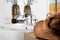 Closeup of a brown color towel and focusing modern white washstand with a faucet in luxurious house or hotel