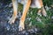 Closeup of a brown female filthy dog urinating on green grass